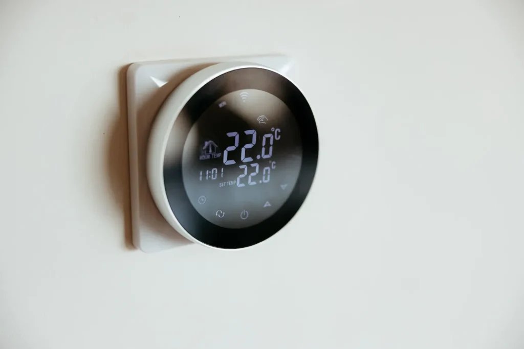 Modern smart thermostat displaying 22 degrees Celsius.